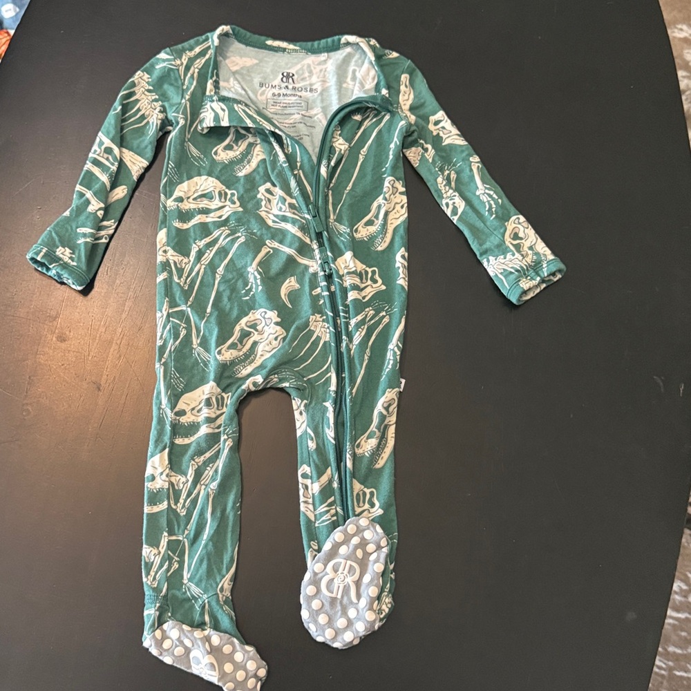 Bums & Roses pjs. Green Baby Onesie with dinosaur bones.